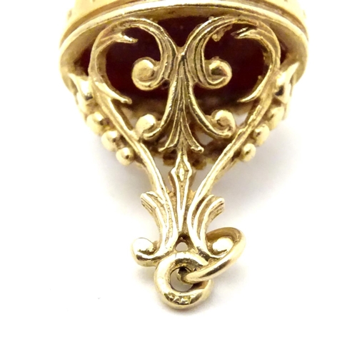 509 - A gilt and gilt metal pendant fob seal with engraved armorial seal under. 3/4