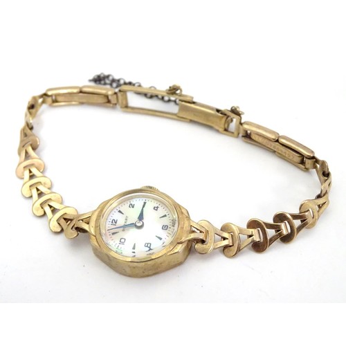 510A - A Rotary 9ct gold cased ladies' wristwatch, fitted with a 9ct gold strap. With Rotary watch case.