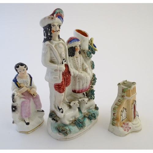 28 - Three items of Staffordshire pottery, to include a figural bud vase, a flatback house and a figure w... 