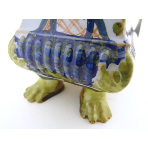 72 - A Continental faience inkwell of sarcophagus form  on four paw feet with hand painted floral decorat... 