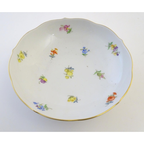 105 - A 19thC Meissen cup and saucer decorated with flowers and gilt highlights. Meissen marks under cup a... 