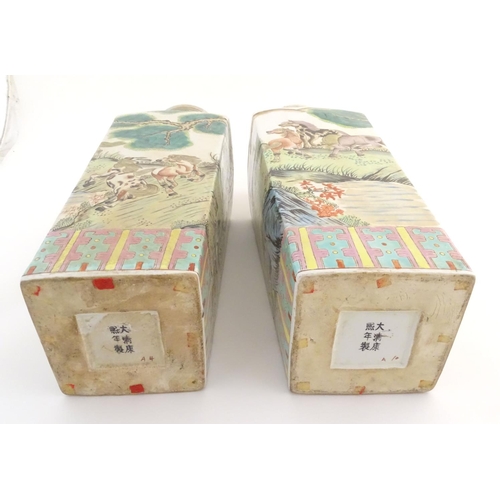 116 - A pair of Chinese square sectional vases with flared rims, decorated with horses in a landscape scen... 