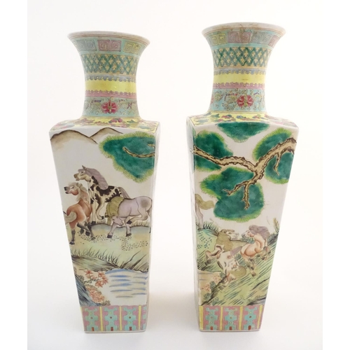 116 - A pair of Chinese square sectional vases with flared rims, decorated with horses in a landscape scen... 