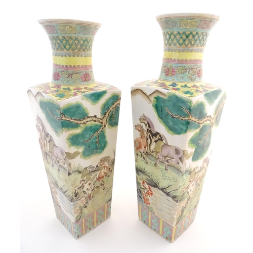 116 - A pair of Chinese square sectional vases with flared rims, decorated with horses in a landscape scen... 