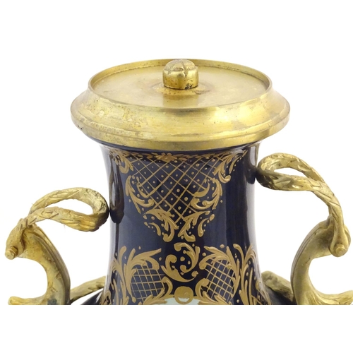 131 - A matched pair of Sevres style lidded urn garnitures on mounted bases, with cobalt blue bodies with ... 