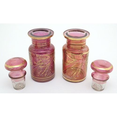 141 - A pair of 19thC cranberry glass jars, each decorated with hand painted vines and bands. 7 1/2