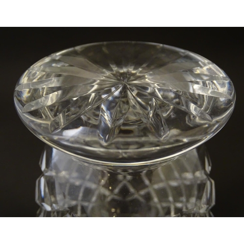 170 - Glass: a 20thC cut crystal decanter, decorated with star, hobnail and block cuts, the next with dual... 