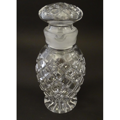 170 - Glass: a 20thC cut crystal decanter, decorated with star, hobnail and block cuts, the next with dual... 