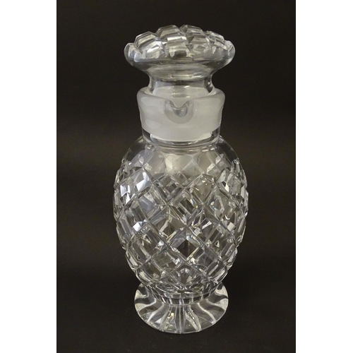 170 - Glass: a 20thC cut crystal decanter, decorated with star, hobnail and block cuts, the next with dual... 