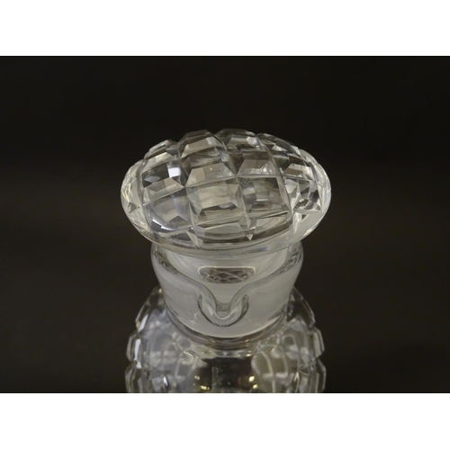 170 - Glass: a 20thC cut crystal decanter, decorated with star, hobnail and block cuts, the next with dual... 