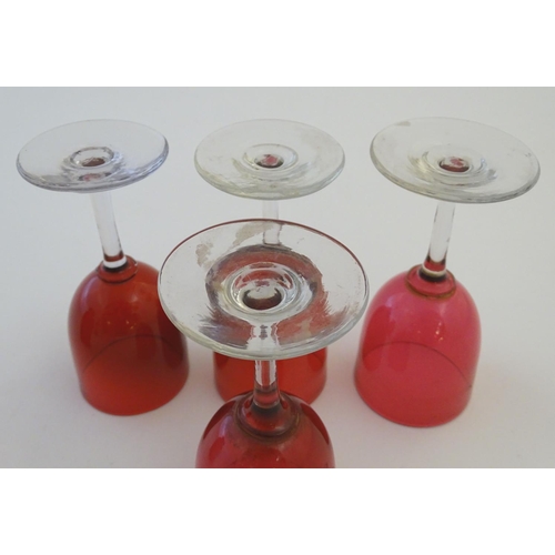 171 - Glass: a set of four Cranberry wine glasses, together with a Cranberry glass jug. The largest 5