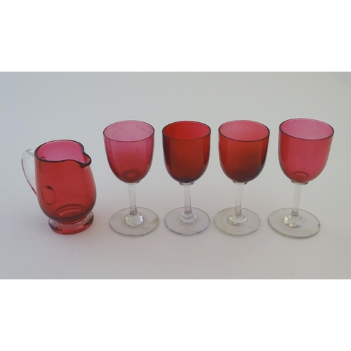 171 - Glass: a set of four Cranberry wine glasses, together with a Cranberry glass jug. The largest 5