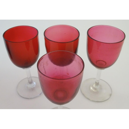 171 - Glass: a set of four Cranberry wine glasses, together with a Cranberry glass jug. The largest 5