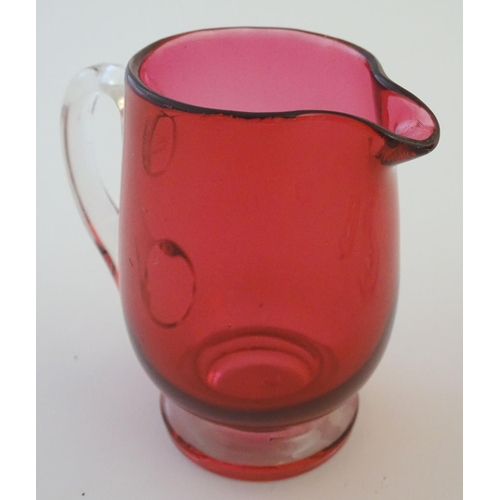 171 - Glass: a set of four Cranberry wine glasses, together with a Cranberry glass jug. The largest 5