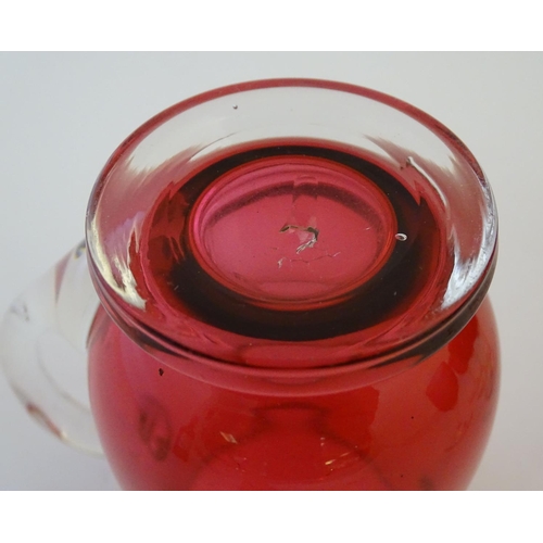 171 - Glass: a set of four Cranberry wine glasses, together with a Cranberry glass jug. The largest 5