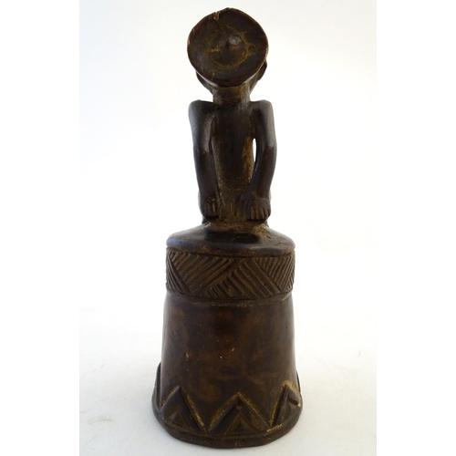 540 - Ethnographic / Native / Tribal: A carved African wooden bell / vessel with geometric detail surmount... 