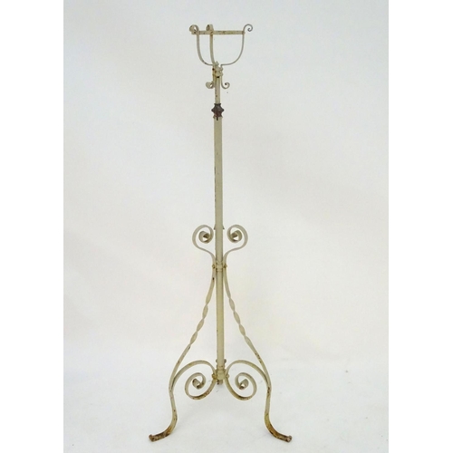 572 - Lighting: a late-Victorian wrought iron and copper lamp stand, with white painted finish, supported ... 