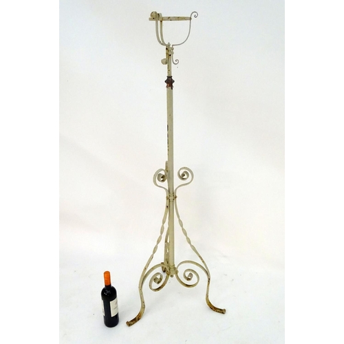 572 - Lighting: a late-Victorian wrought iron and copper lamp stand, with white painted finish, supported ... 
