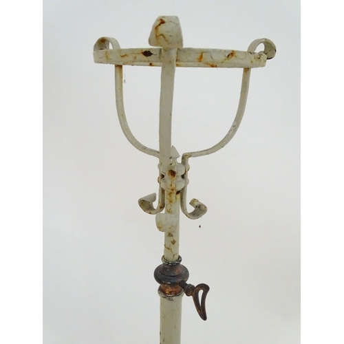 572 - Lighting: a late-Victorian wrought iron and copper lamp stand, with white painted finish, supported ... 