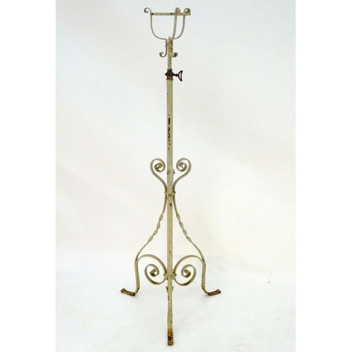 572 - Lighting: a late-Victorian wrought iron and copper lamp stand, with white painted finish, supported ... 