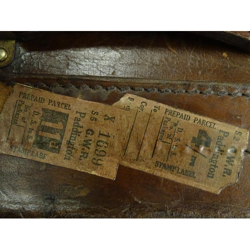 856 - A late 19thC leather travelling trunk flanked by carrying handles. 34