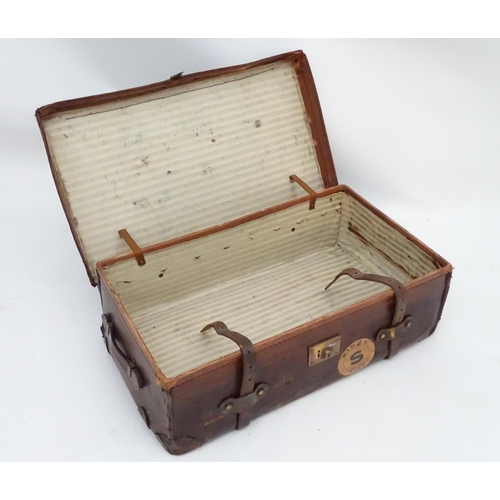 856 - A late 19thC leather travelling trunk flanked by carrying handles. 34