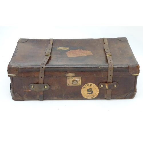 856 - A late 19thC leather travelling trunk flanked by carrying handles. 34