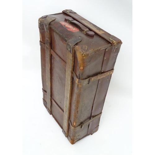 856 - A late 19thC leather travelling trunk flanked by carrying handles. 34
