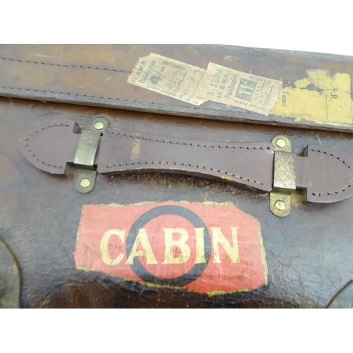 856 - A late 19thC leather travelling trunk flanked by carrying handles. 34