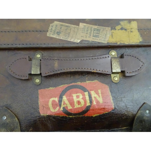 856 - A late 19thC leather travelling trunk flanked by carrying handles. 34