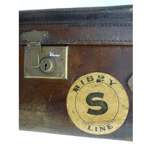 856 - A late 19thC leather travelling trunk flanked by carrying handles. 34