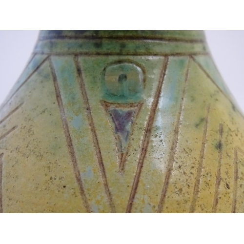 103 - A 20thC studio pottery baluster vase with incised geometric decoration. Impressed G maker's mark und... 