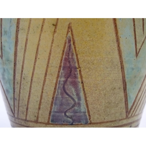 103 - A 20thC studio pottery baluster vase with incised geometric decoration. Impressed G maker's mark und... 