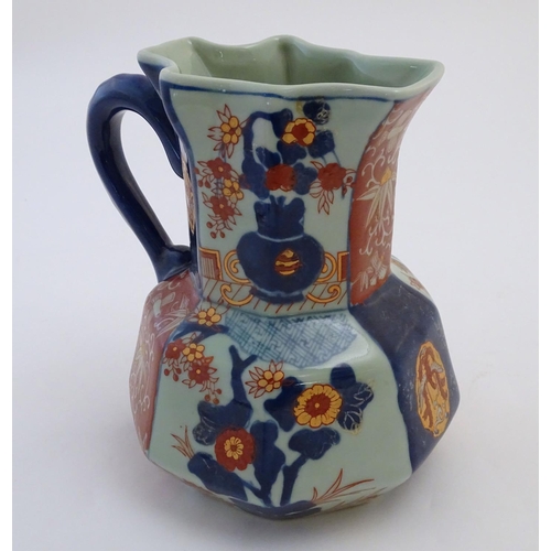 107 - A Victoria Ware ironstone octagonal jug decorated in the Imari palette with floral and bird decorati... 