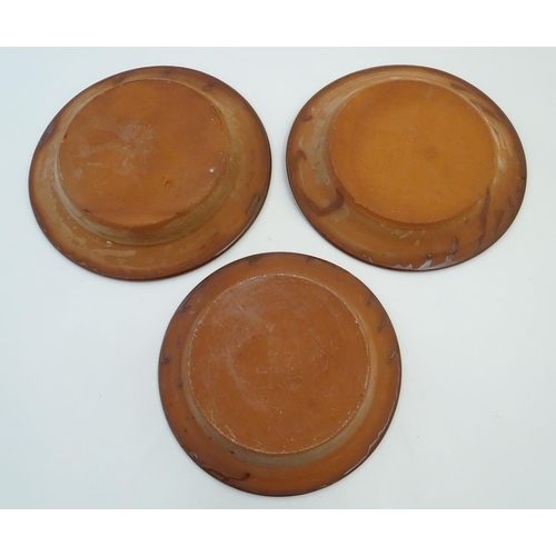 109 - Three 20thC slipware chargers decorated with abstract patterns. One with impressed H maker's mark. L... 