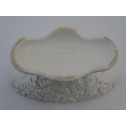 110 - A Sylvac posy holder / vase, the body moulded with a leaf pattern in a white glaze. Approx. 6 1/4