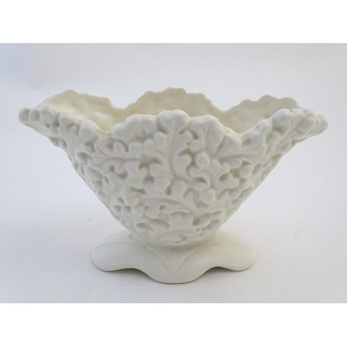 110 - A Sylvac posy holder / vase, the body moulded with a leaf pattern in a white glaze. Approx. 6 1/4