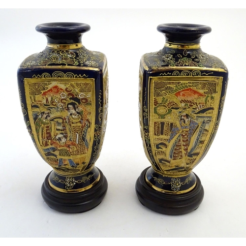 124 - A pair of Japanese Satsuma vases of square baluster form with a cobalt blue ground, with panelled de... 