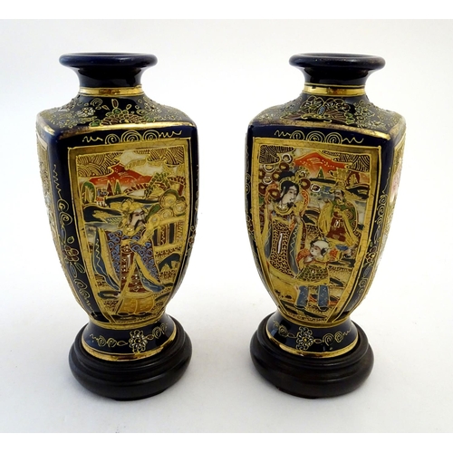 124 - A pair of Japanese Satsuma vases of square baluster form with a cobalt blue ground, with panelled de... 