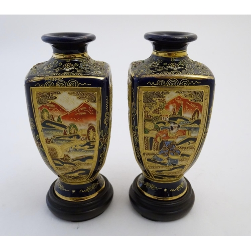 124 - A pair of Japanese Satsuma vases of square baluster form with a cobalt blue ground, with panelled de... 