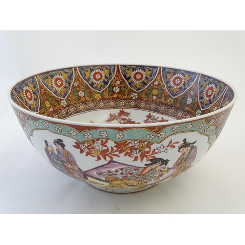 126 - A large Japanese bowl with hand painted decoration the central roundel depicting figures / geisha gi... 