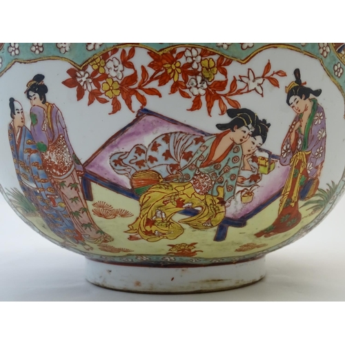 126 - A large Japanese bowl with hand painted decoration the central roundel depicting figures / geisha gi... 