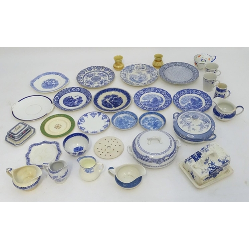 129 - A large quantity of assorted blue and white ceramic wares, to include jugs, plates, vases, butter / ... 