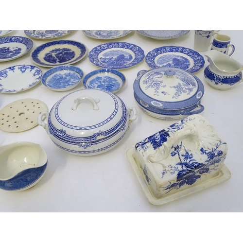 129 - A large quantity of assorted blue and white ceramic wares, to include jugs, plates, vases, butter / ... 