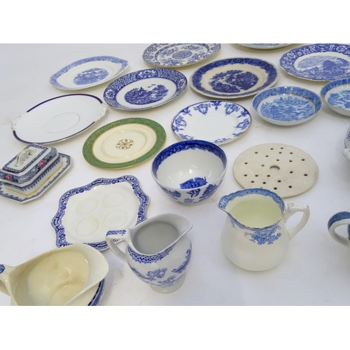 129 - A large quantity of assorted blue and white ceramic wares, to include jugs, plates, vases, butter / ... 