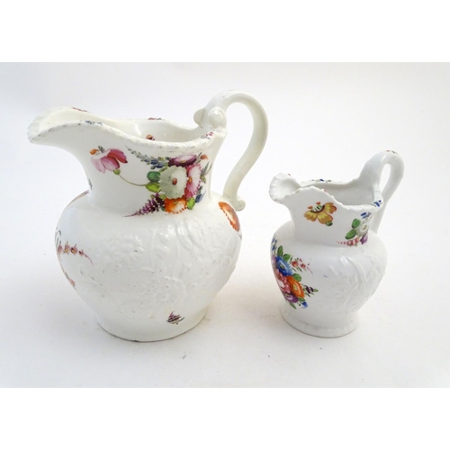 133 - Two 19thC jugs with relief floral decoration and hand painted flowers. Tallest approx. 6 3/4