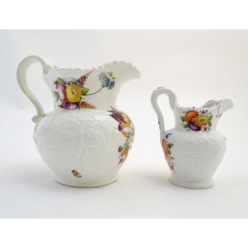 133 - Two 19thC jugs with relief floral decoration and hand painted flowers. Tallest approx. 6 3/4