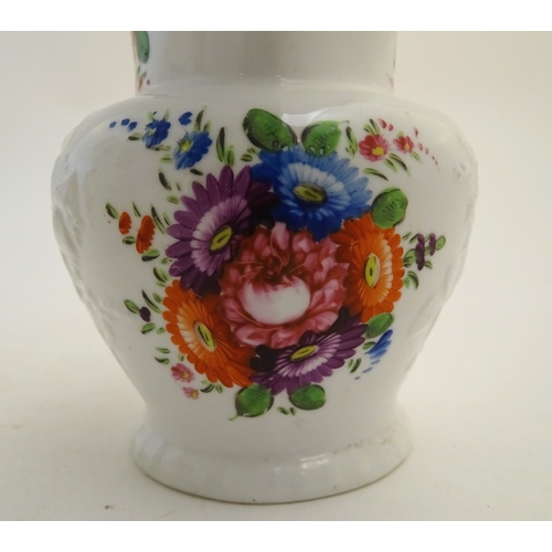 133 - Two 19thC jugs with relief floral decoration and hand painted flowers. Tallest approx. 6 3/4