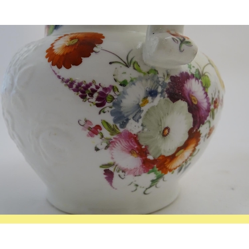 133 - Two 19thC jugs with relief floral decoration and hand painted flowers. Tallest approx. 6 3/4