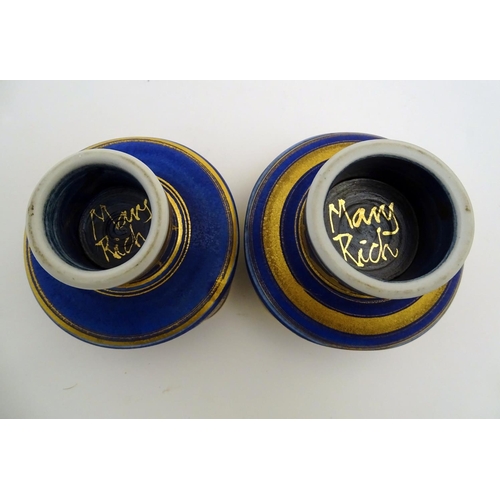 69 - A matched pair of studio pottery footed squared bowls / pots with cobalt blue and gilt geometric dec... 